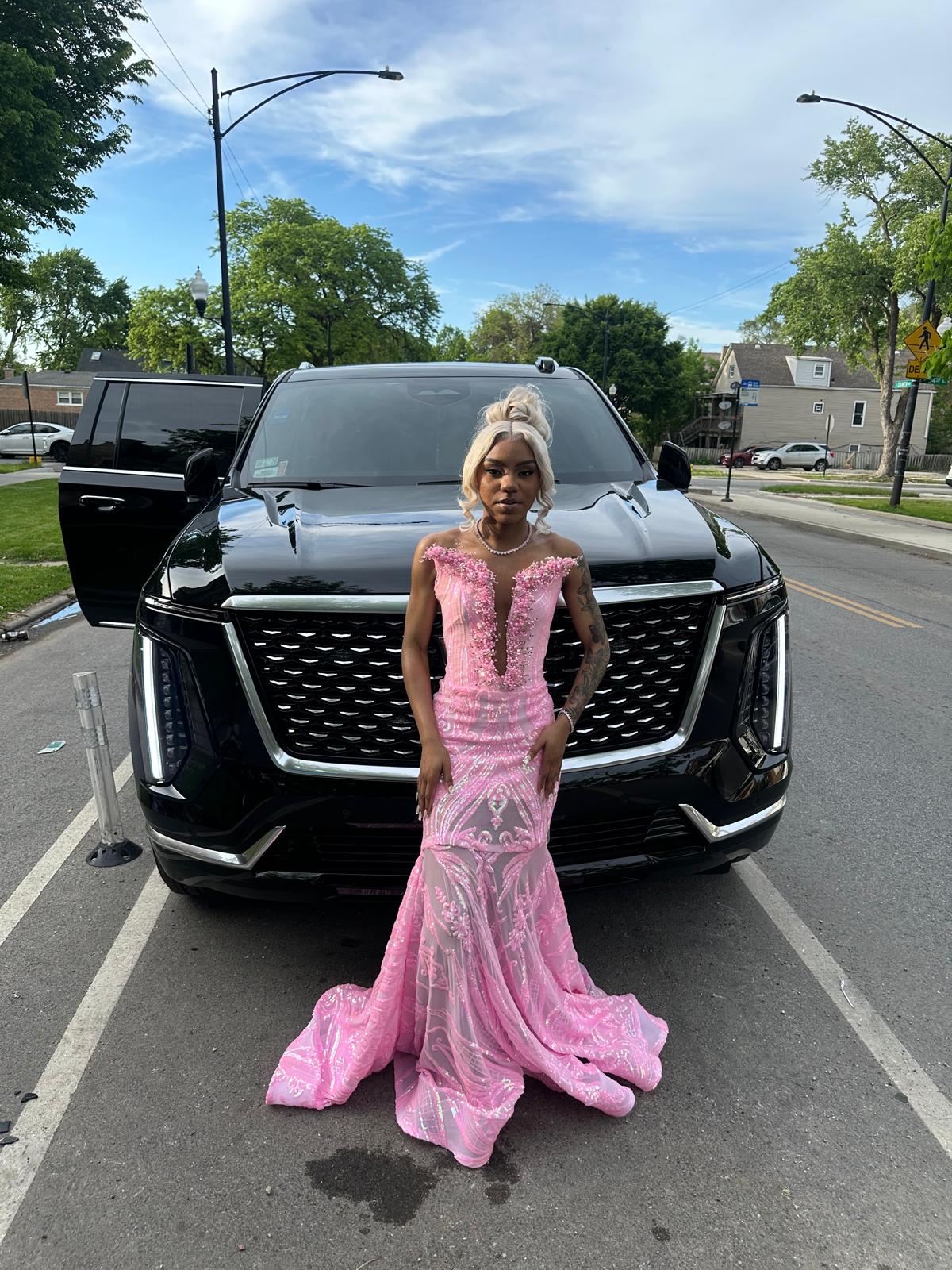 Prom client posing in front of the vehicle