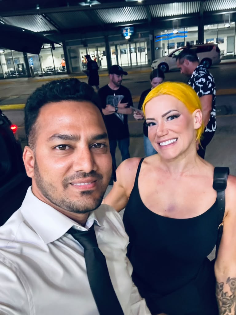 Chauffeur with a client at the terminal at night
